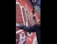 egg roll taped to red brick wall