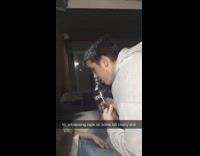 guys persuading girls white shirt  to take vodka shot 