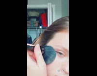 Girl does makeup on camera lip gloss 