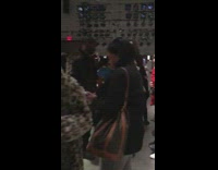 Woman wearing giant white Dollar Bill money clip outfit