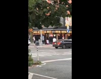 Man holds vacuum cleaner fight on street