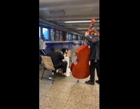 Guy black suit white tablecloth cello instrument 