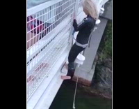 Black Wetsuit Girl Jumps off White Bridge to Swing From Rope and Faceplants
