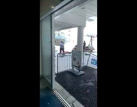 Man in black sweater rides and poses on the snowmobile