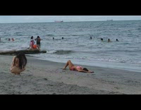 Woman pink bikini lay and pose beach