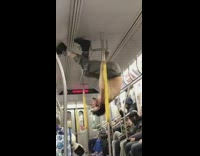 Guy upside down on rails says hes a hustler on subway train