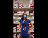 Girl blue shirt puts sandal onto arm elbow nub