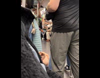 Man shirtless performs inside the subway train
