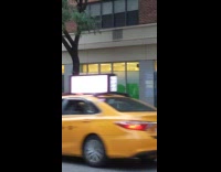 Lady white sleeves green underwear walks sidewalk 