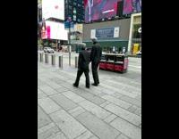 Two people wearing alien costumes times square