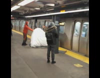 Guy rushes to get couch onto subway 