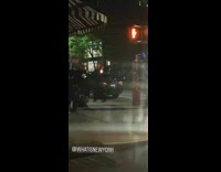 Guy black jacket swinging LED balls sidewalk