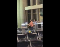Two women tiktok dance at the airport lobby