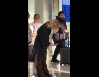 Woman black robe tiktok at the airport