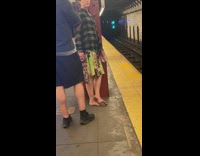 Barefoot person waits for train 