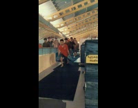 Guys hold weights do lunges around gym