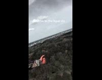 Army guy hanging from helicopter