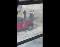 Three girls hold starbucks pose behind ambulance