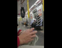 Guy uses hand support rails on subway to do calisthetics
