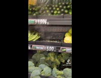 Woman shopping for broccolinis 