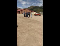 Snowboarders Take Group Photo Together near Parking 