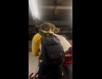 Man yellow hoodie cat on nape subway