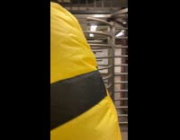 Person wears a minion costume and rides subway