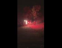 Woman twerk on hill night red light