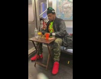 Guy prepare his food with small table inside the train at NY 