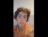 Guy stares at camera then spits out a plastic basketball