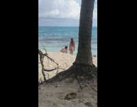 Woman in beige bikini with handprints on the butt at the beach