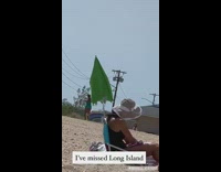 Lady chases umbrella blowing away by wind