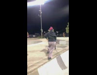 Guy and girl poses for a photo in skate park