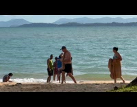 Tour guide teaches family for beach photo