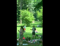 Guy at the park in shrek makeup practicing for a play with friend