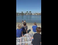 Kids boys look at woman bikini beach