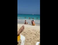 Lady wearing bikini poses at beach