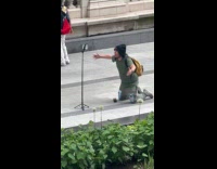 Man kneels for tiktok video at park