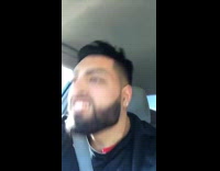 Guy shakes his head fast to the beat of Headlines by Drake in his car