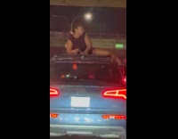 Woman twerk on car roof night highway