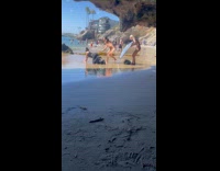 Woman black pants bend on the beach