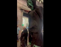 Person wears skull head costume on Halloween 