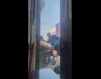 Guy gives man a haircut in wheelchair on street 