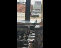 Red pants guy sits poses white car 