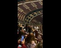 Three women tiktok dance on the stadium bleachers