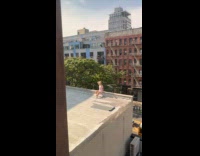 Collab WINY - Woman onesie sit pose on building ledge
