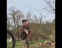 Guy jumps off small ramp with bicycle and opens friends beer bottle with his wheels