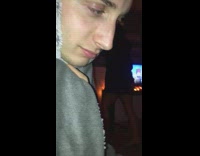 Guy in grey looks at camera and then slowly falls on the floor 