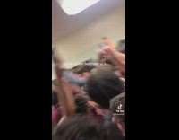 Boys in restroom jump and sing 