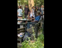 Alien play chess with man at park